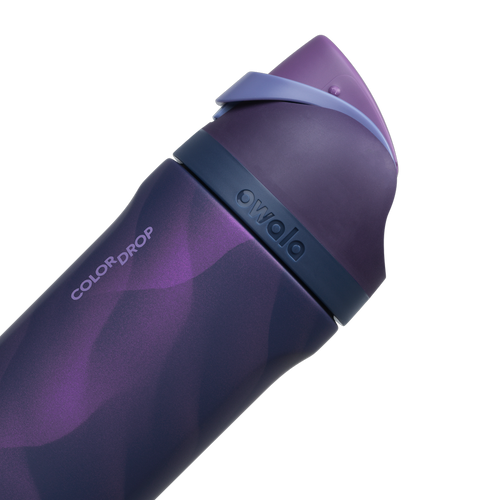 Owala FreeSip 24oz in Arctic Storm, deep purple body with wavy lavender pattern, dark navy lid with periwinkle carry loop and matching deep purple flip cap